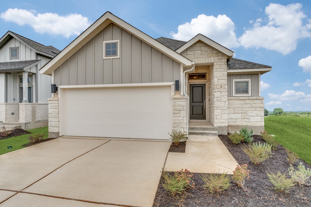 a house with a garage door in front of it