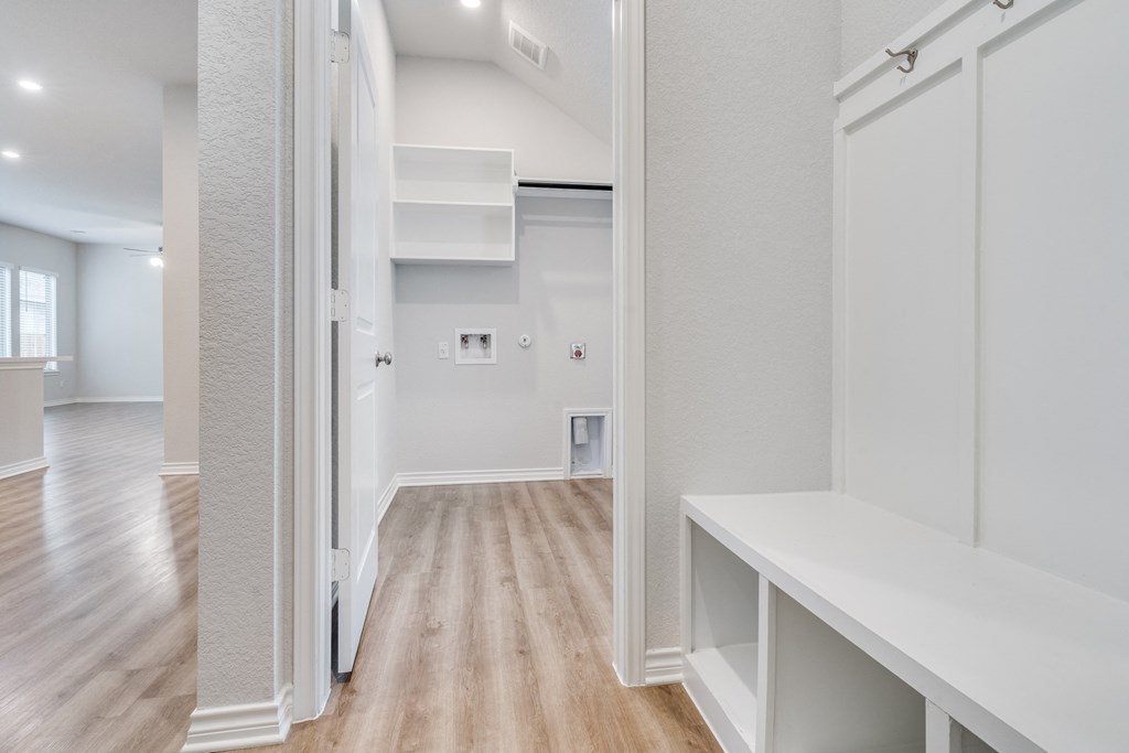 the living room of a new home with white walls and wood floors