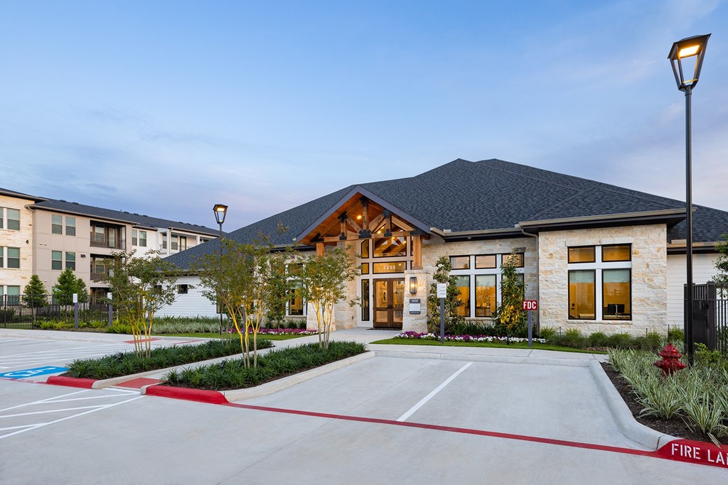 a large building with a parking lot and a fire hydrant in front of it