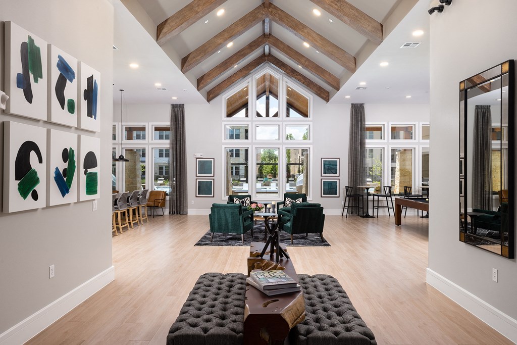 a large living room with a vaulted ceiling and large windows