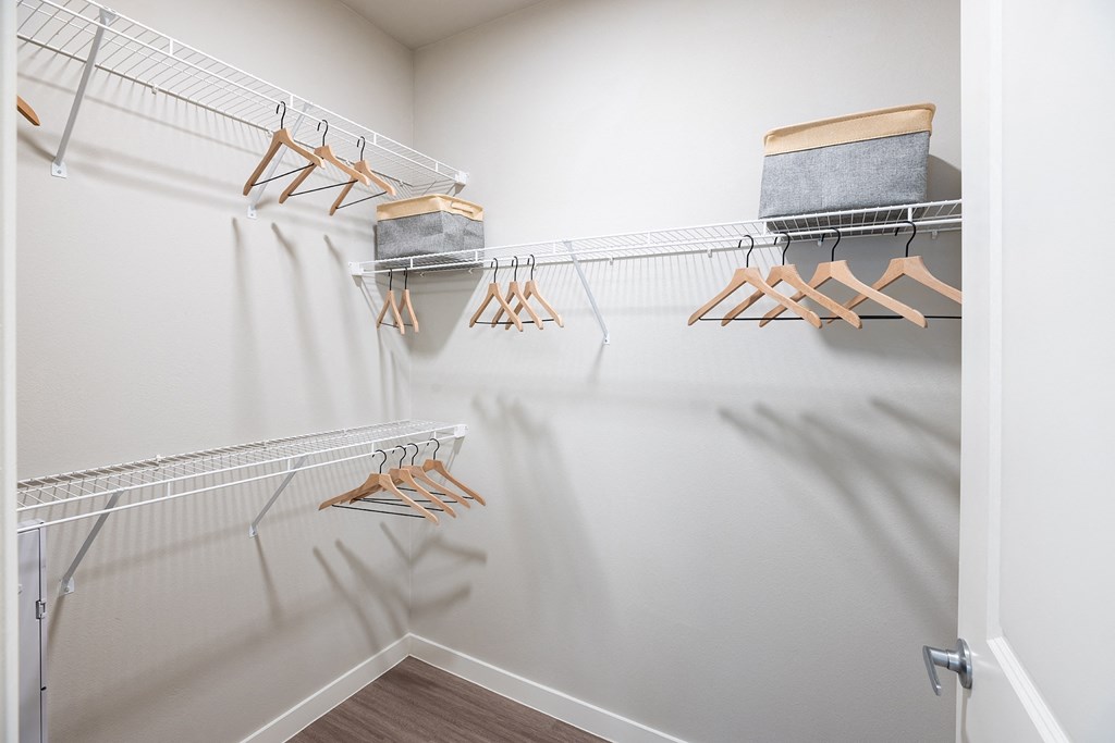 a spacious walk in closet in the enclave at woodbridge apartments in sugar land, tx