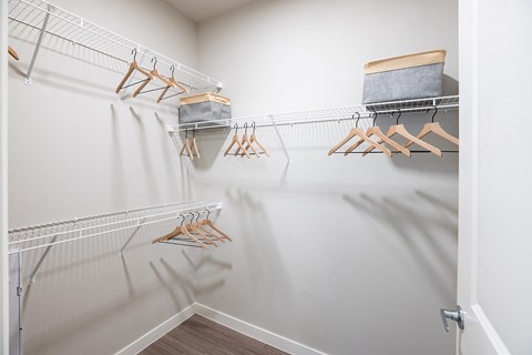 a spacious walk in closet in the enclave at woodbridge apartments in sugar land, tx