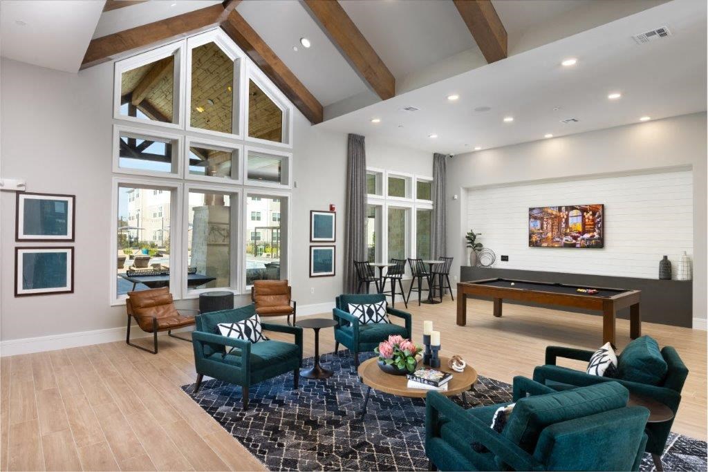 a game room with a pool table and chairs