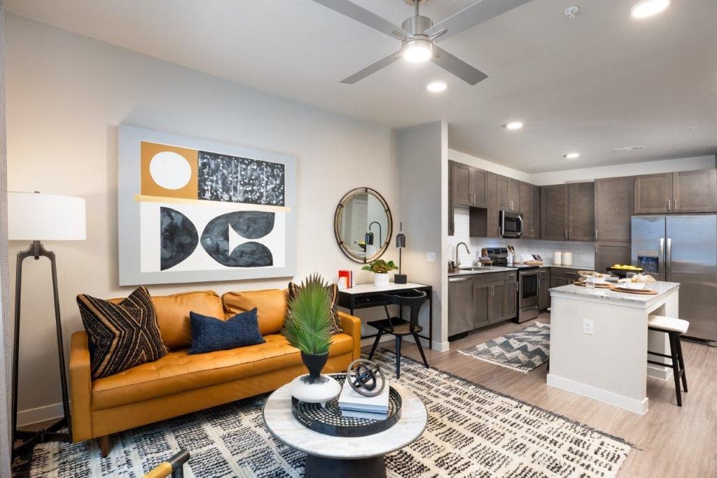 a living room and kitchen with a couch and a table