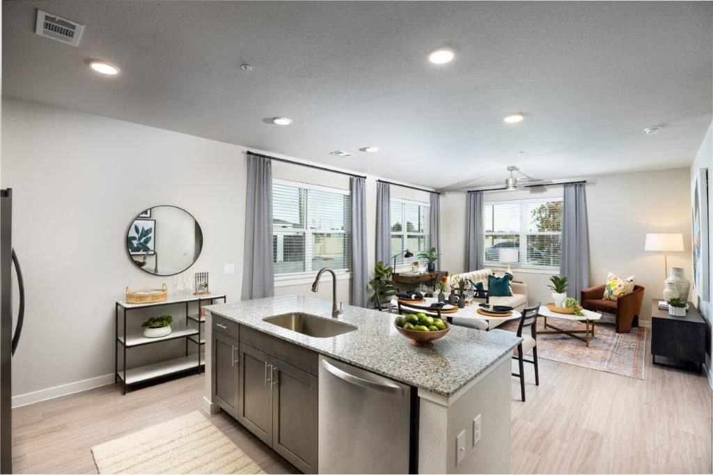 an open kitchen and living room with a large window
