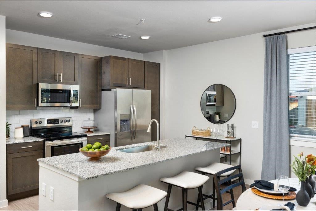 a kitchen with a marble counter top and a