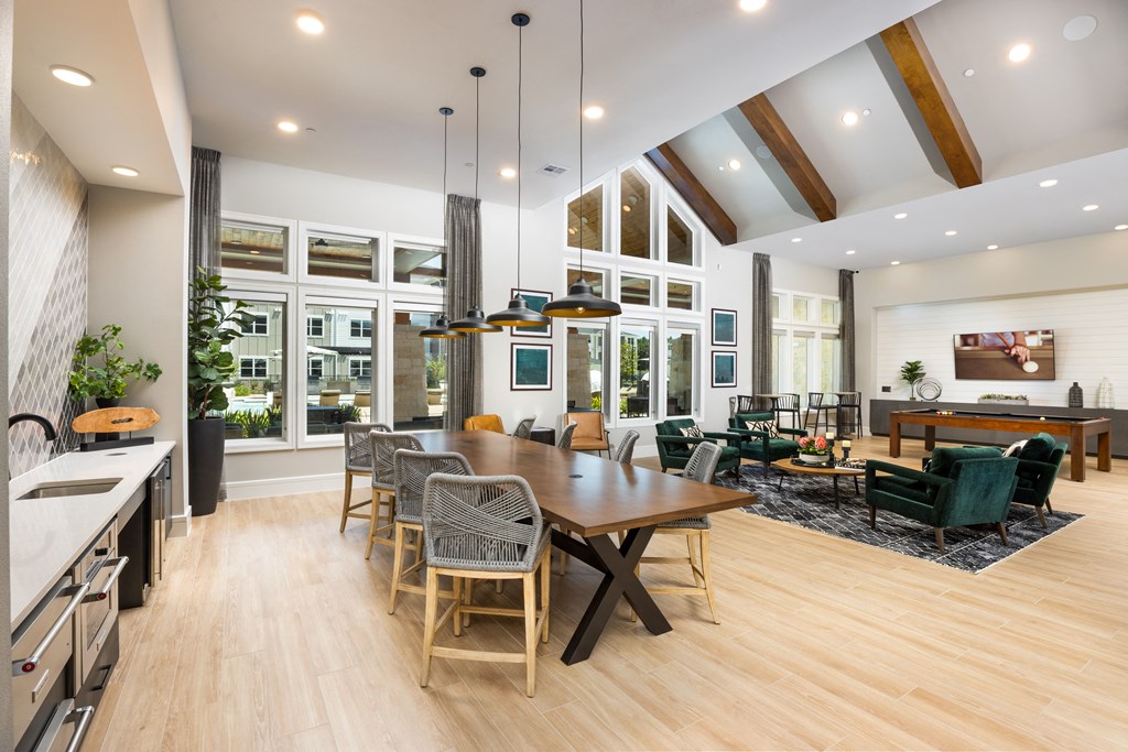a large open living room with a dining room table and chairs