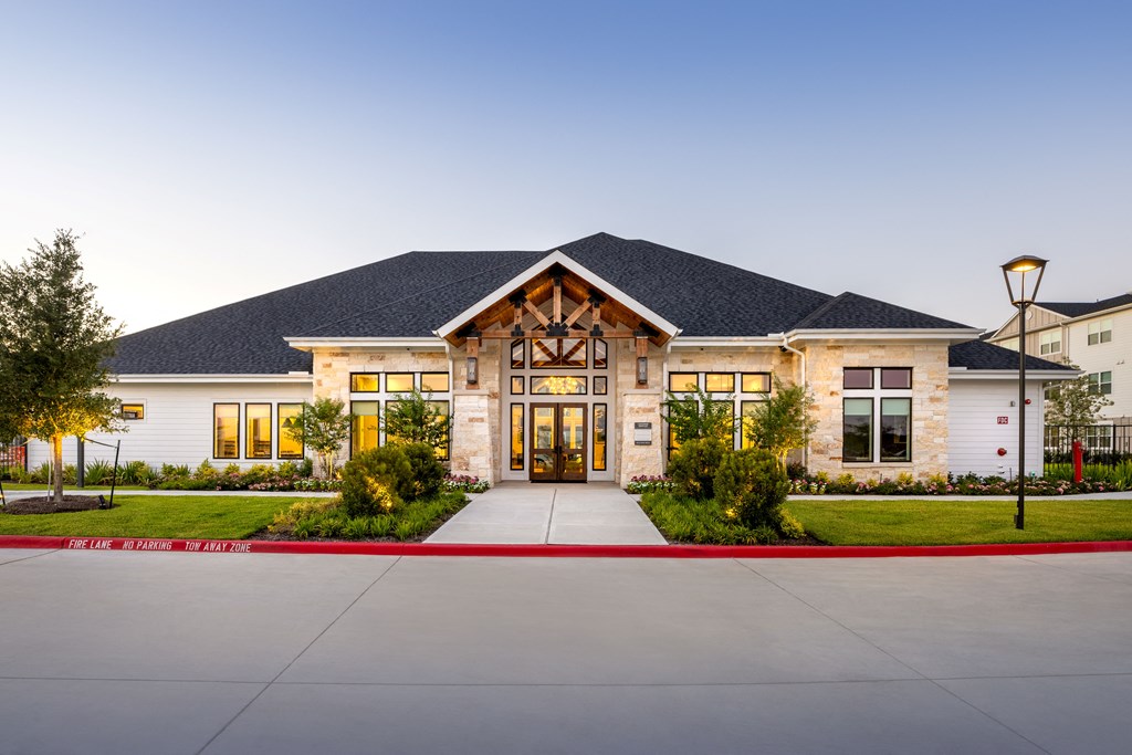 a large home with a large driveway and a large wooden door