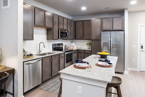 a kitchen with stainless steel appliances and granite counter tops