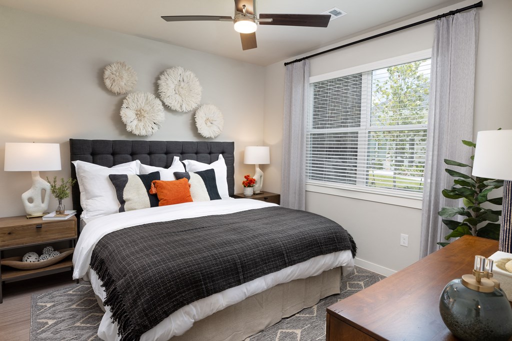 a bedroom with a large bed and a large window