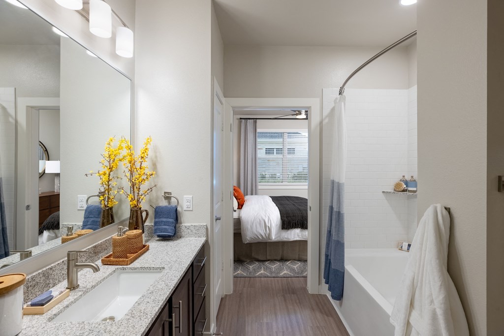 a bathroom with two sinks and a bathtub in a 555 waverly unit