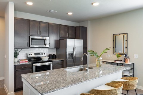 a kitchen with stainless steel appliances and a granite counter top