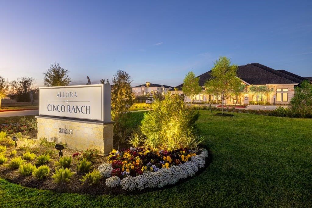 a building with a sign in front of a garden