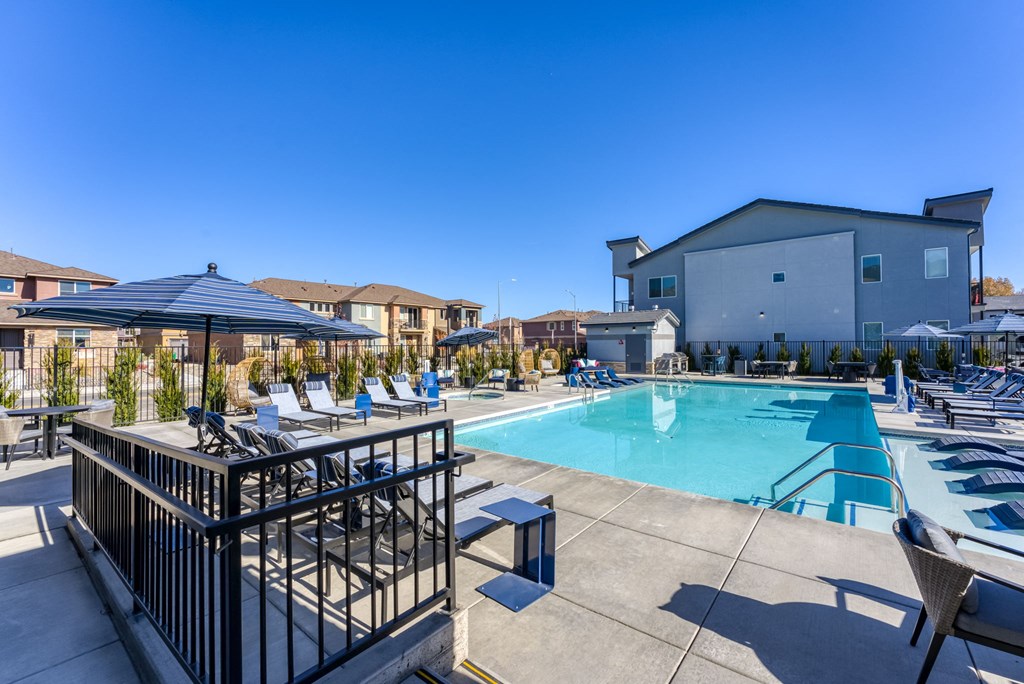 our apartments have a swimming pool with lounge chairs and umbrellas