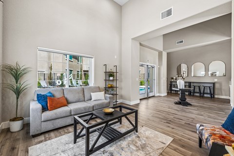 A living room with a grey couch and a black coffee table.