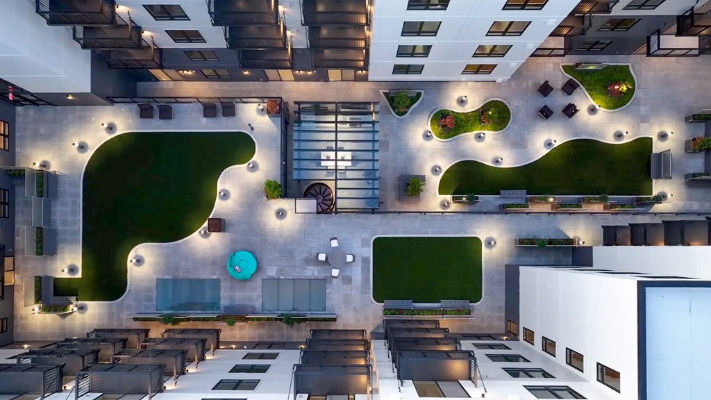 A modern building with a courtyard and a clock on the wall.