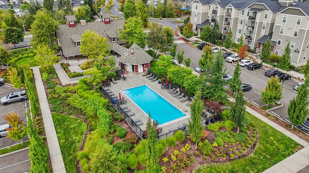 A bird's eye view of a residential area with a swimming pool.