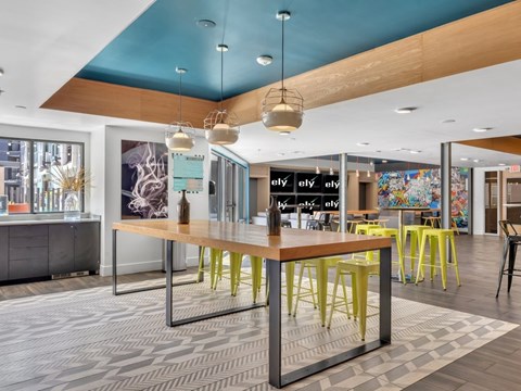 A modern office space with a long table and chairs.