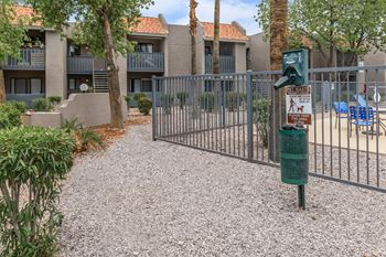 A gated community with a sign that says "No Parking" and a dog walking sign.