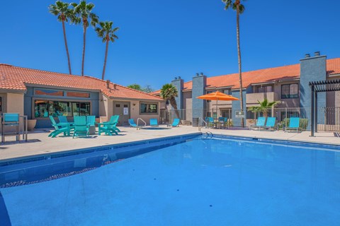 Swimming pool with lounge seating area at Peak at Oro Valley Apartments, Tucson, AZ