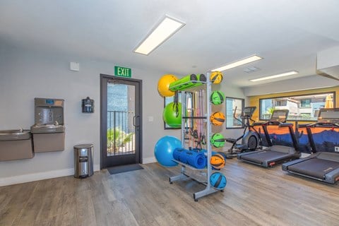 Fitness center with cardio equipment and weights at Peak at Oro Valley Apartments, Tucson, Arizona