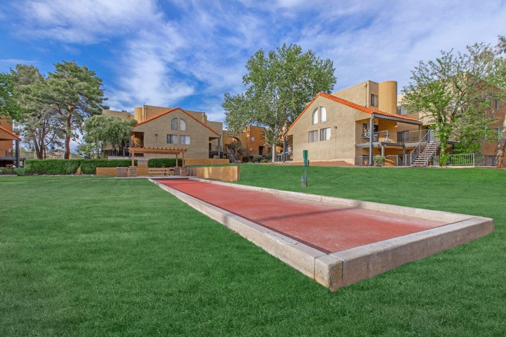 A red track is in the middle of a grassy area.