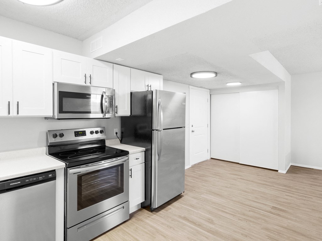 Proximity Apartment Homes Kitchen with stainless steel appliances and white cabinets