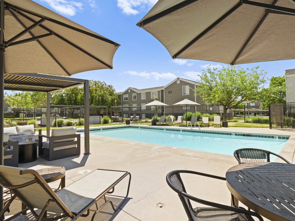 Proximity Apartment Homes Pool with lounge chairs and tables