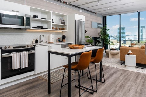 a kitchen and dining area with a table and chairs