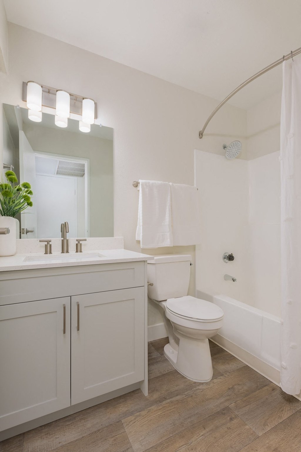 a white bathroom with a toilet and a sink