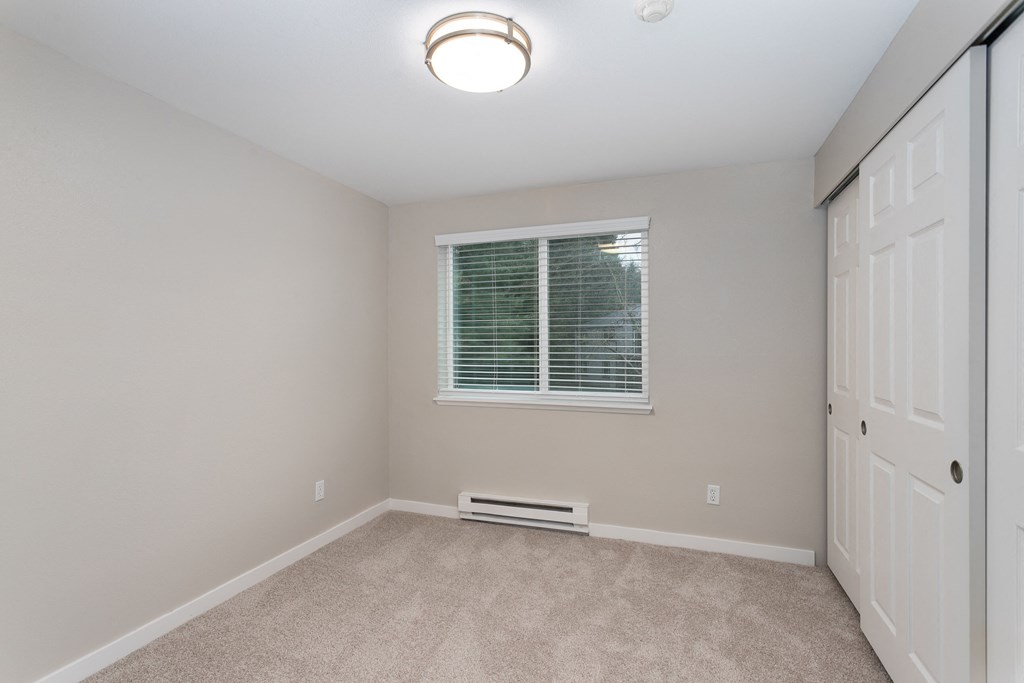 Novela Apartments Bedroom with Closet Door and Window