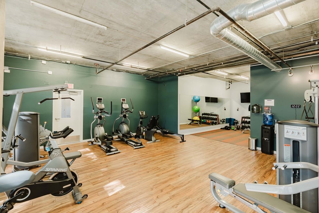 A gym with a variety of exercise equipment.