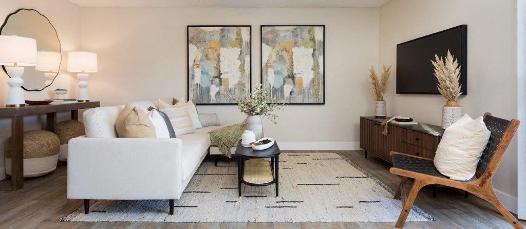 a living room with a white couch and a table