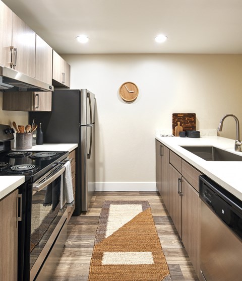 a kitchen with stainless steel appliances and wooden cabinets