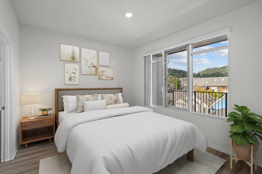 a bedroom with a bed and a large window