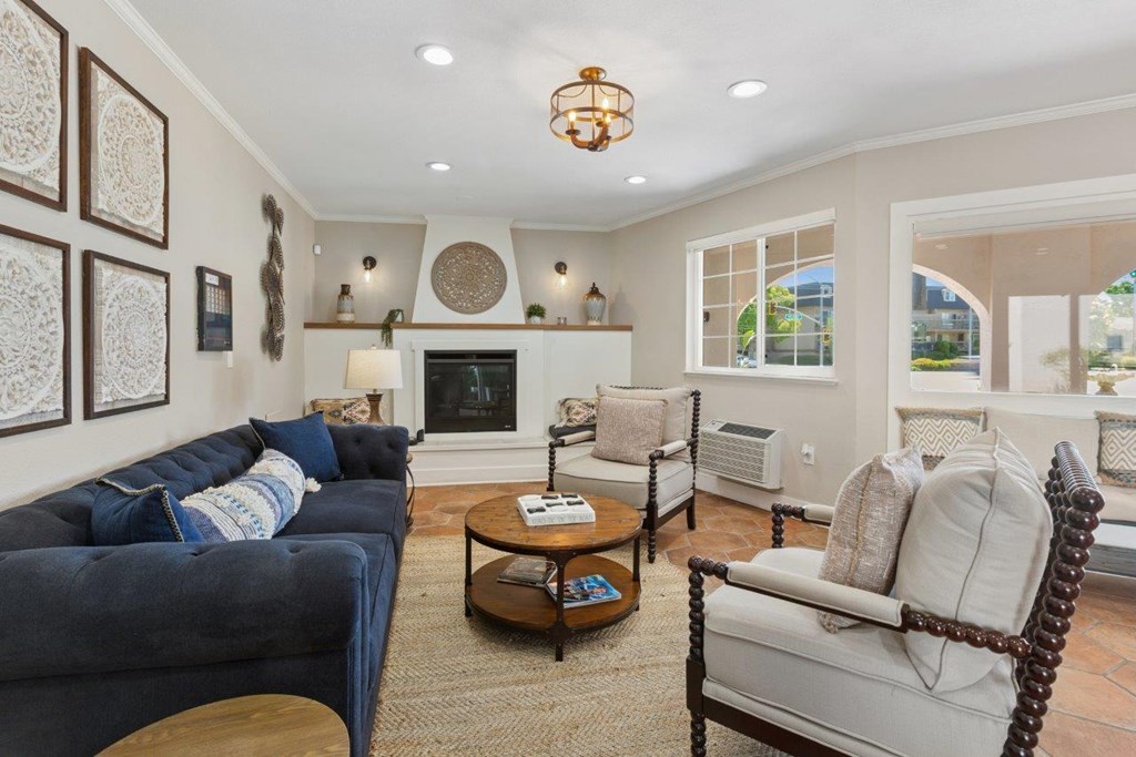 A living room with a blue couch and a white chair.