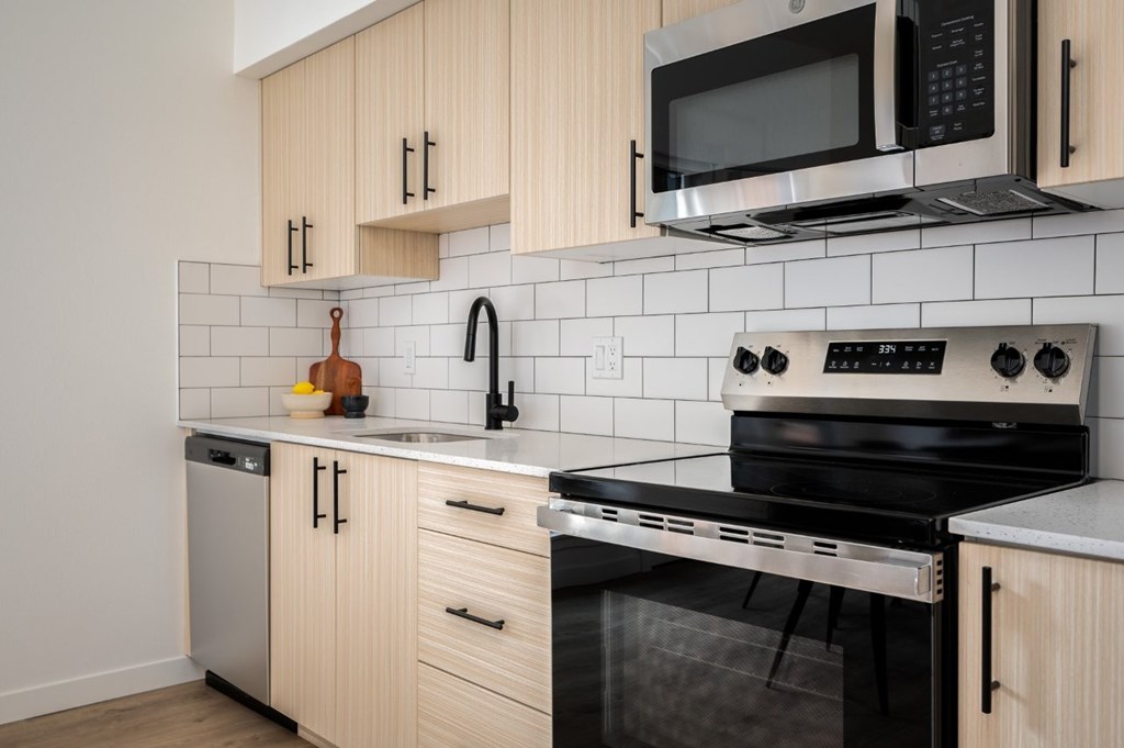 The Wes Gresham Oregon Apartments bright kitchen with stainless steel appliances