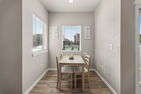 A dining room with a table and chairs.