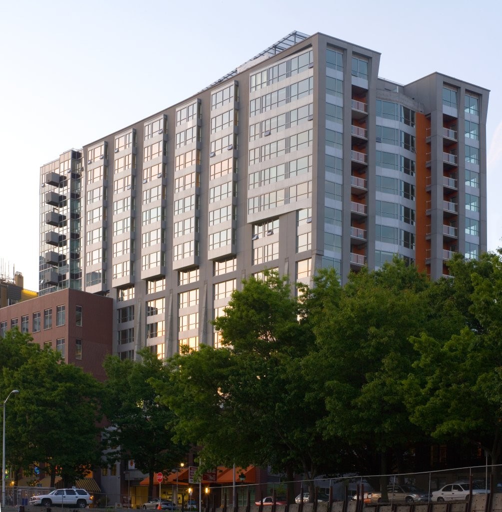 A modern multi-story building with a lot of windows and balconies.