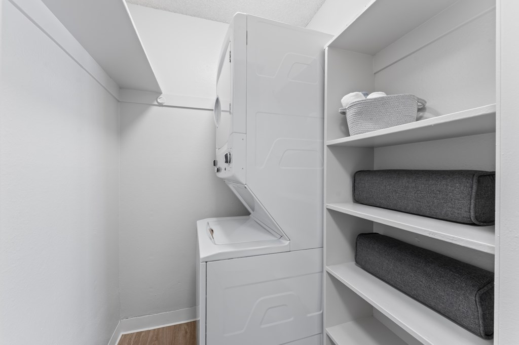A white laundry room with a washer and dryer.