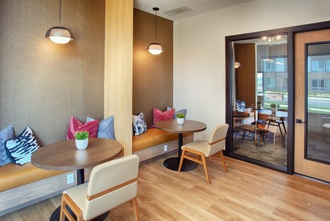 A modern dining area with a round table and chairs.
