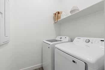 A white washing machine and dryer in a small laundry room.