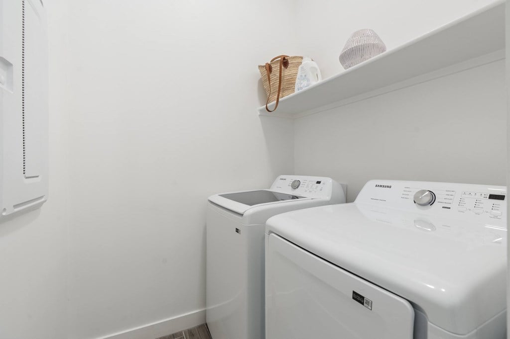 A white washing machine and dryer in a small laundry room.