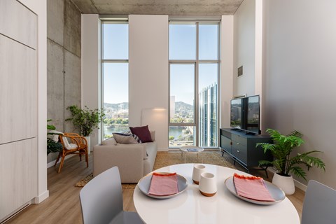 A modern dining room with a table set for two.