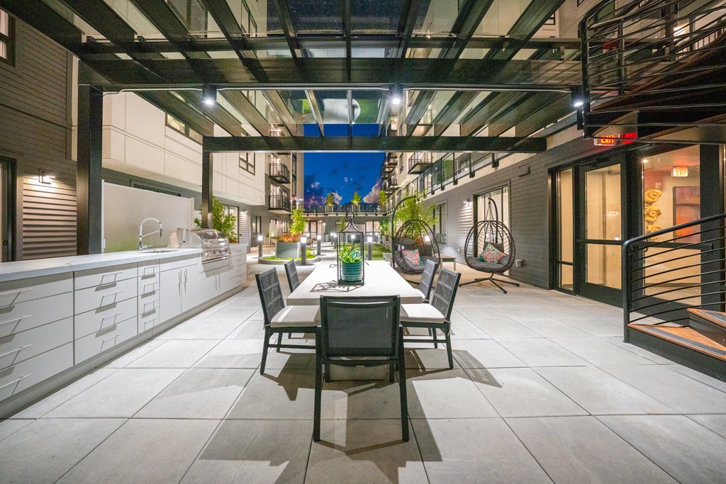 A patio with a table and chairs is set up on a rooftop.