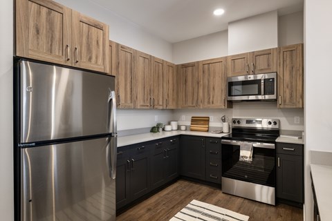 A modern kitchen with wooden cabinets and stainless steel appliances.