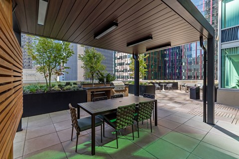 a dining area with a table and chairs on a patio
