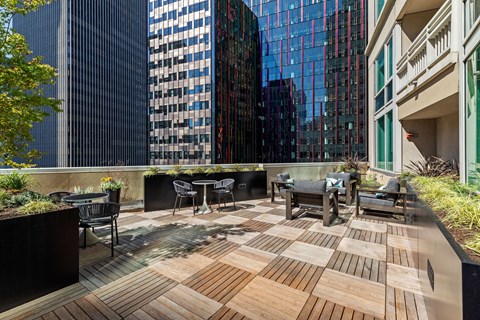 a patio with a view of skyscrapers and tables and chairs