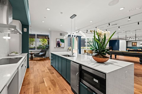 a kitchen with a large white counter top and green cabinets