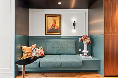 a living room with a couch and a painting on the wall